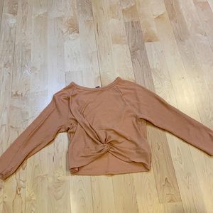 Pink shirt knotted at the bottom